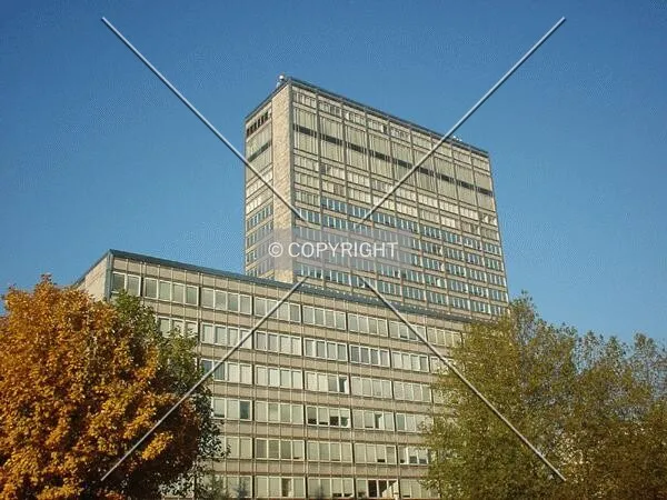 The low-rise building in front of the tower