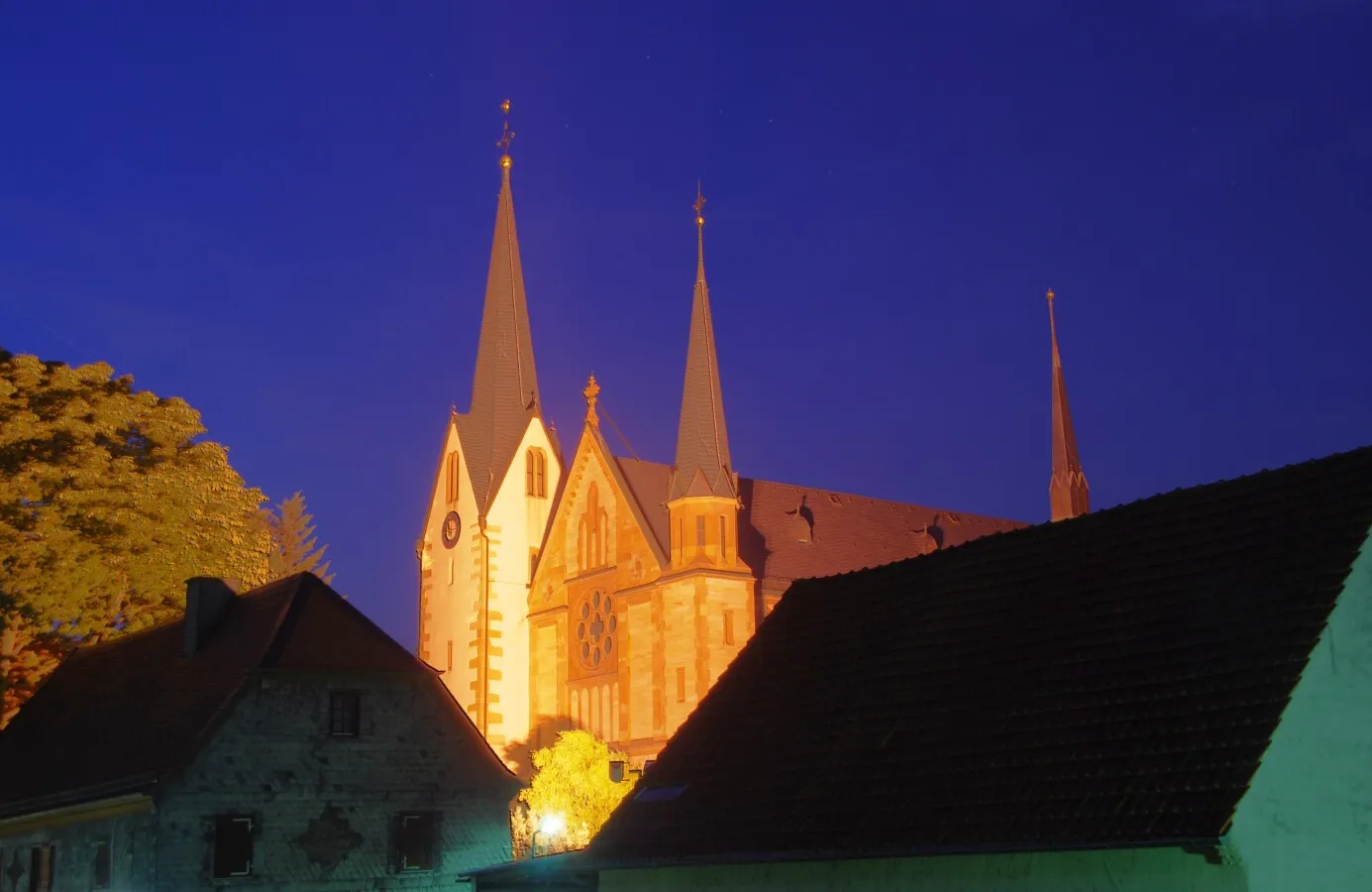 Church spires shining behind dark roofs