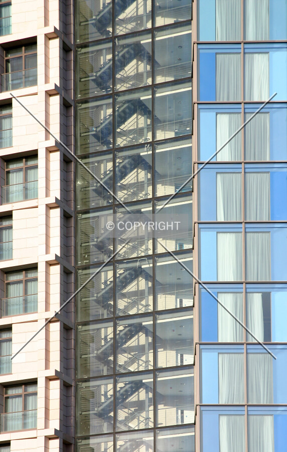 Contrasting façade styles either side of the emergency stairs on the south side