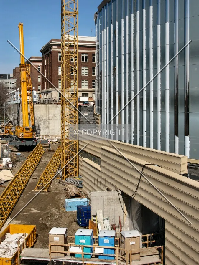 View to the north along the west facade, with partially-dissembled tower crane