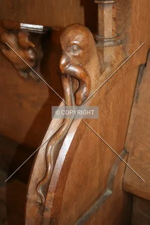Wood carving of a bird eating a worm