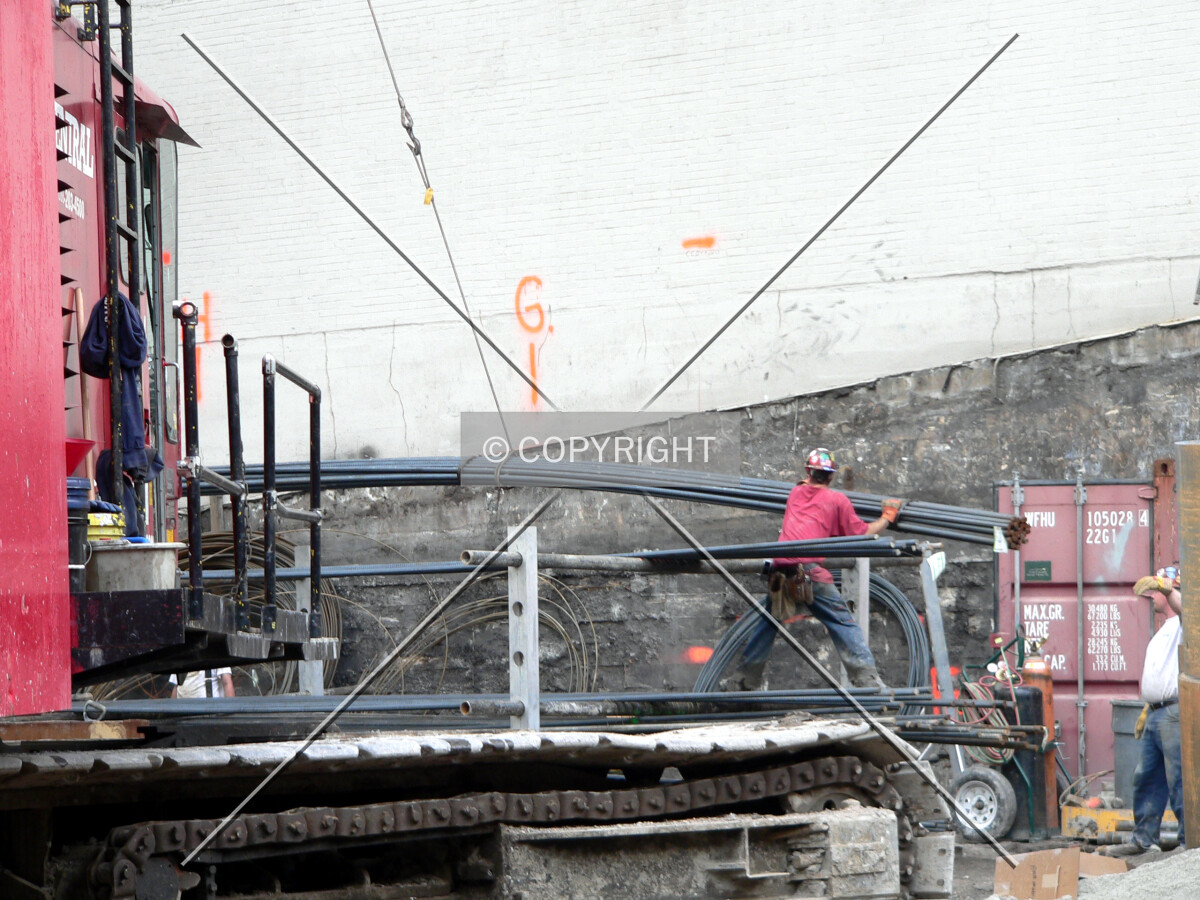 Rebar being lowered into place in order to fabricate cages