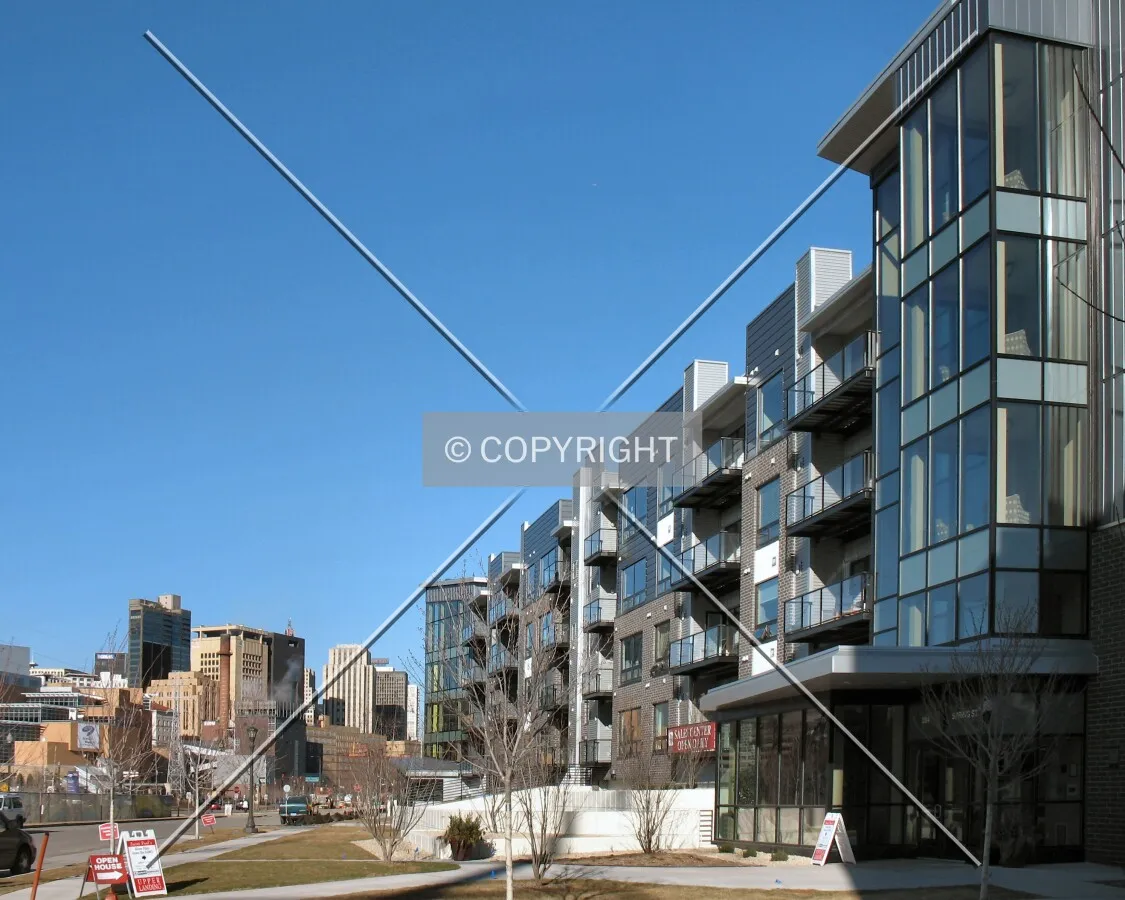 View to the northeast along the front facade, downtown skyline in the distance
