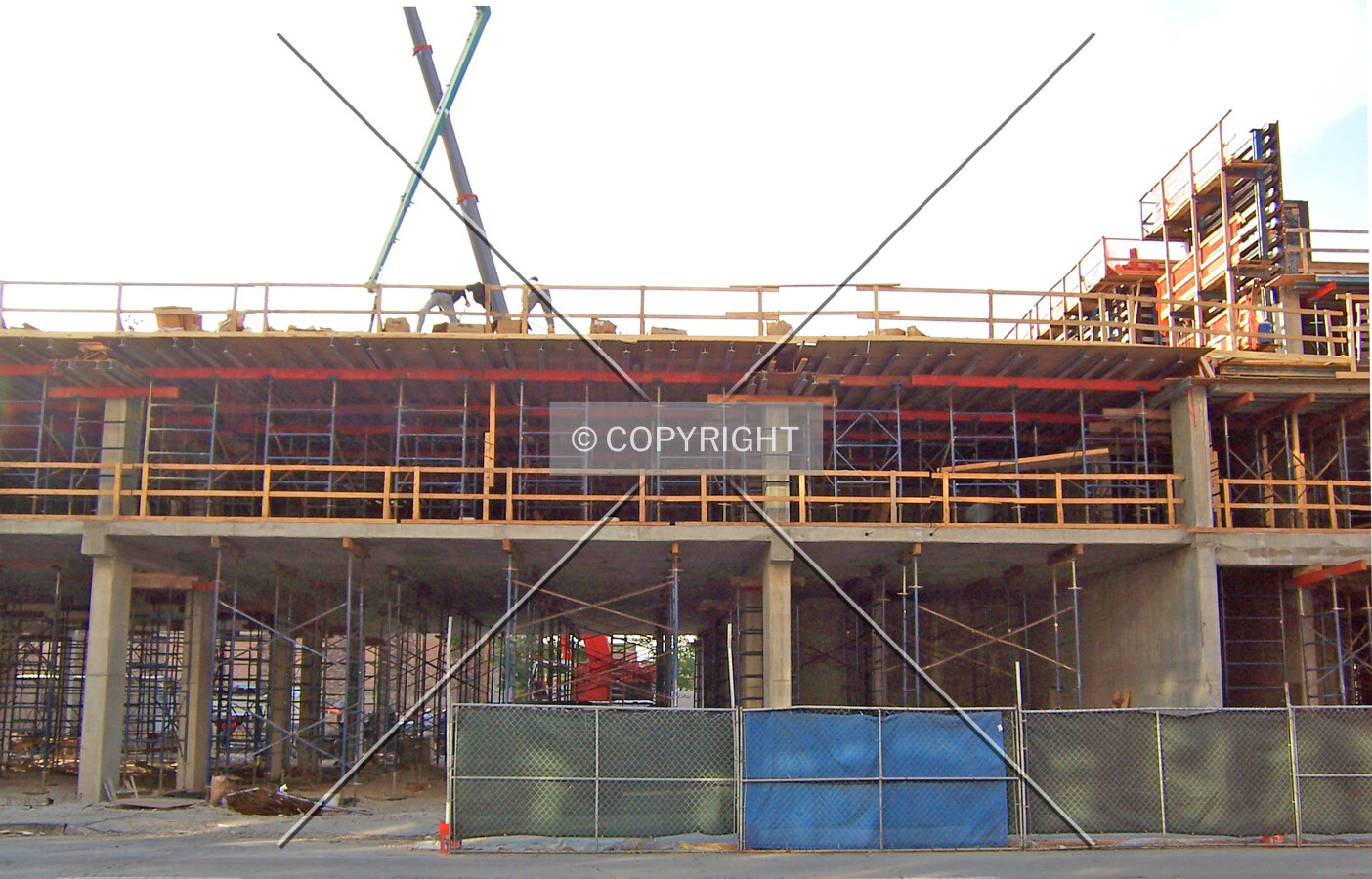 Center of the building along Michigan Avenue. Workers are using the boom of the pump to spread concrete across the second floor slab