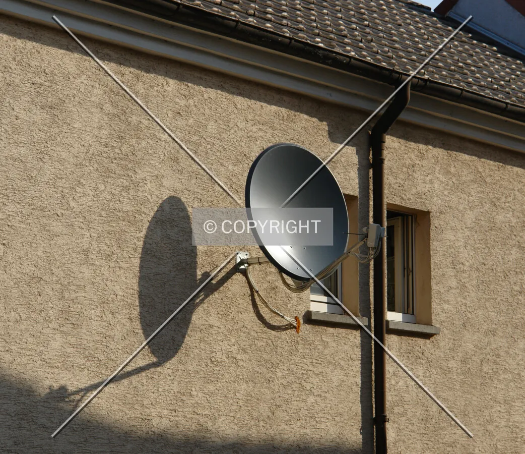 A satellite dish mounted on a wall