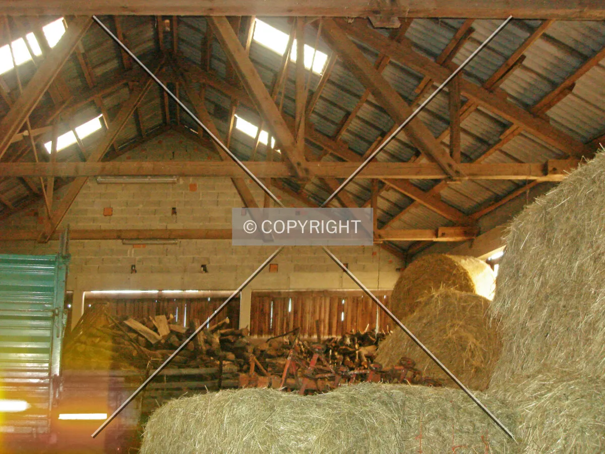 A barn containing hay and wood