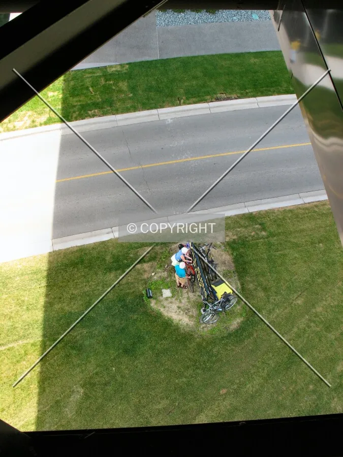 Looking down at West River Parkway and resting cyclists from the Lower Terrace of the Endless Bridge