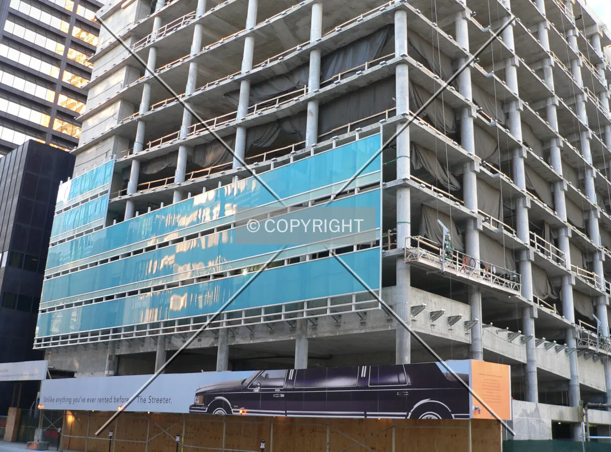 Glass being installed on the parking structure