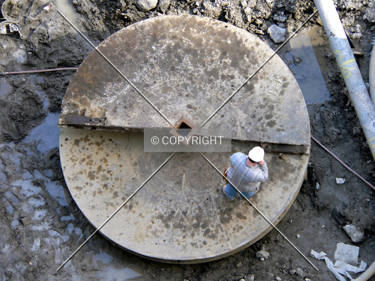 A worker standing on one for the caisson drill bits