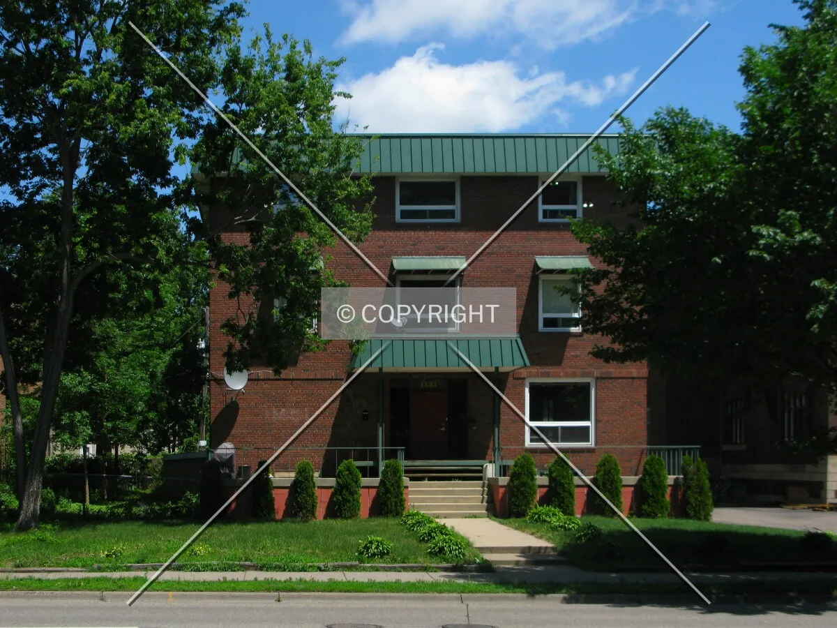 Full front elevation from across University Avenue SE