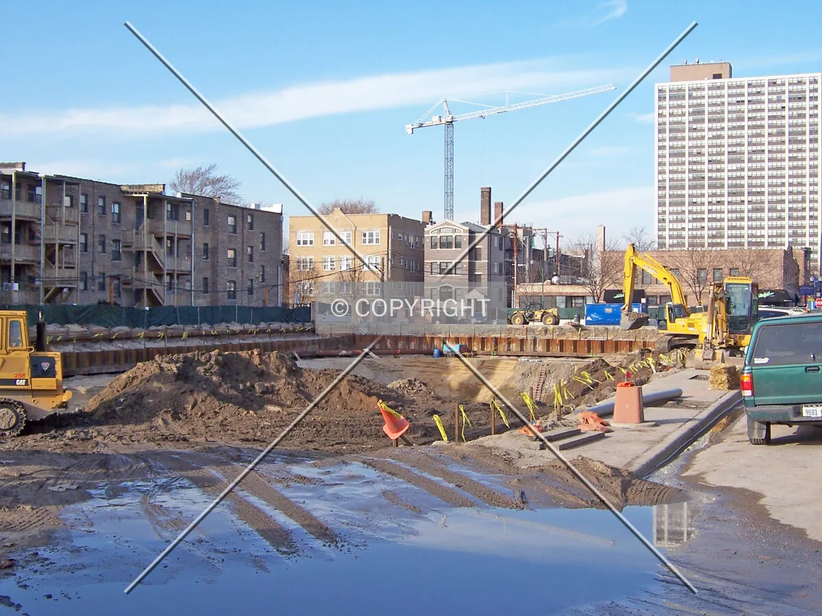 Distant view of the tower crane from the south, overlooking the site of the new low-rise Center on Halsted building under construction in the foreground