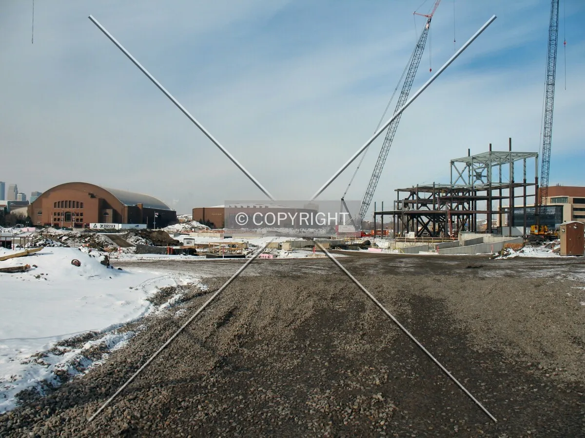 View across center of site from main construction entrance; WIlliams & Mariucci Arenas in distance