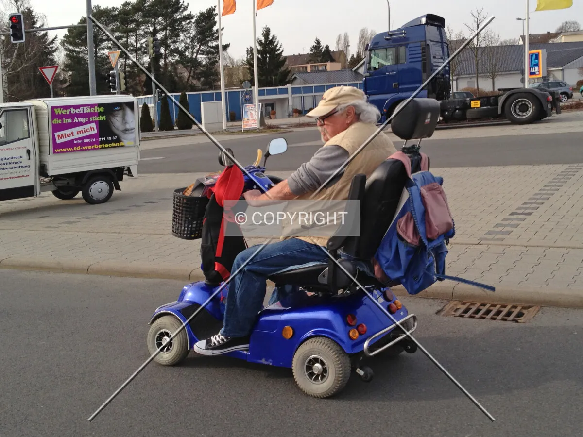 A man is driving a motorized wheelchair