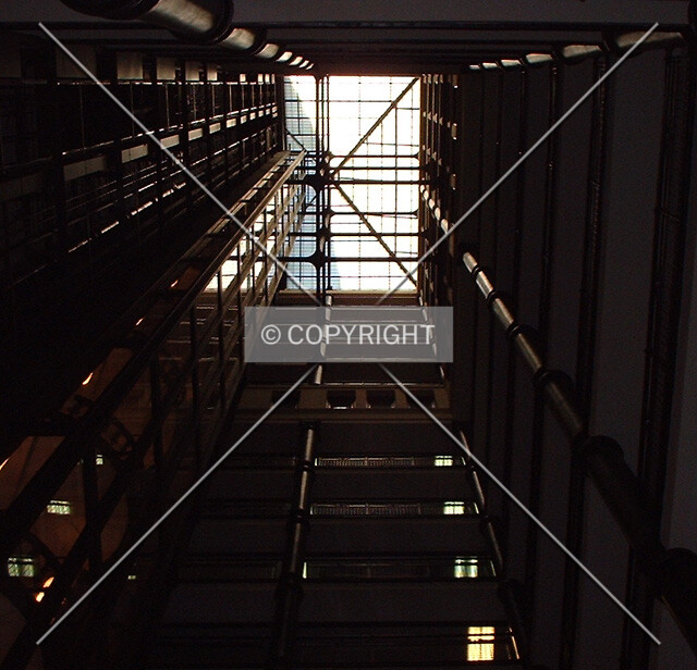 Looking up in the interior light court, elevators on the left