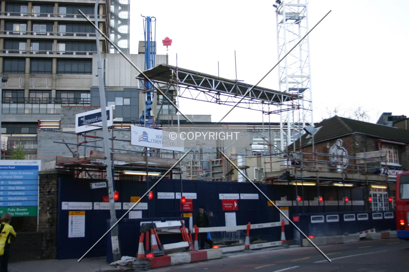 Steel reinforcing rods peeping over the hoarding from Fleet Road