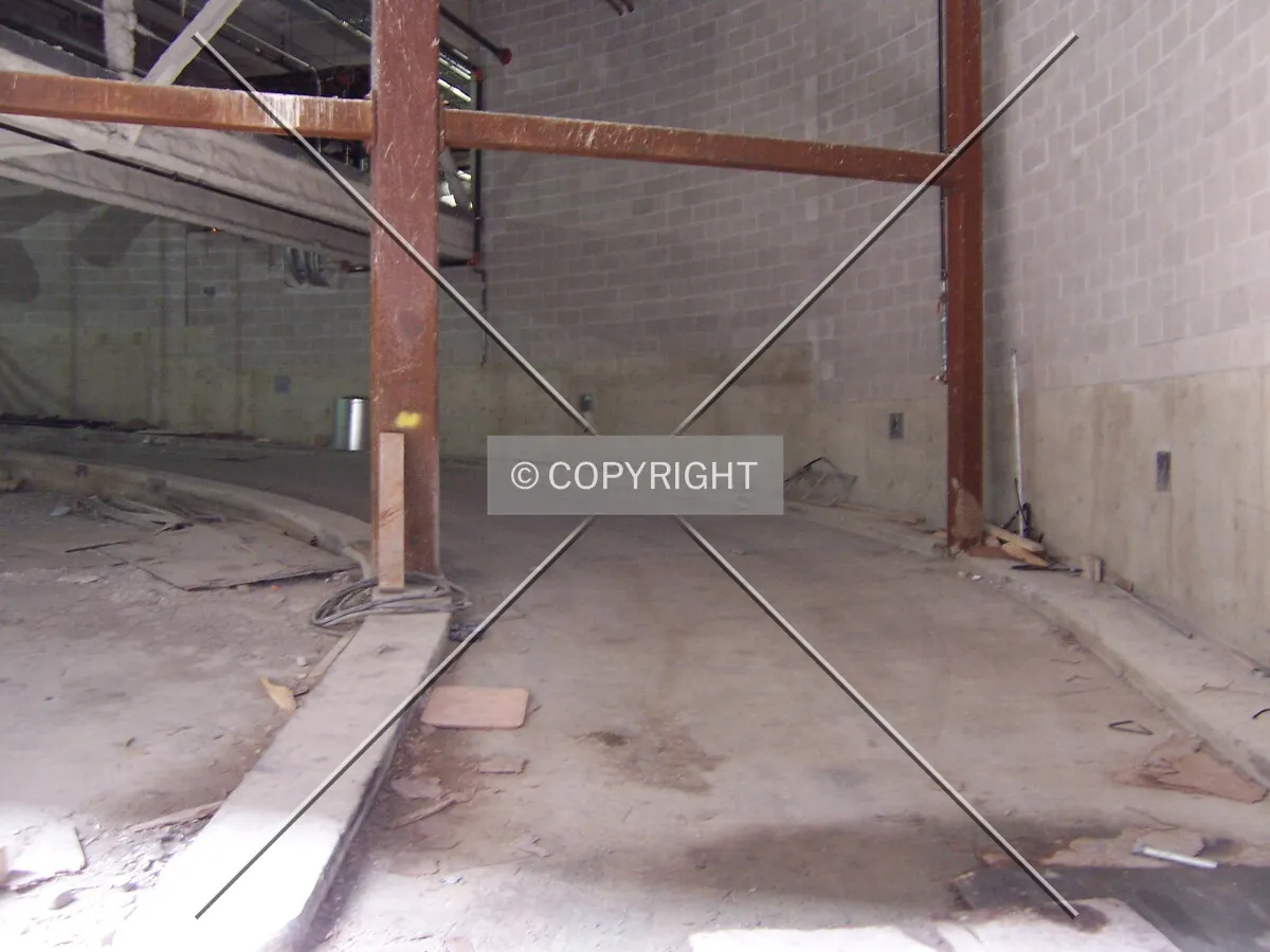 Looking into the parking garage entrance from the alley along the east side of the tower