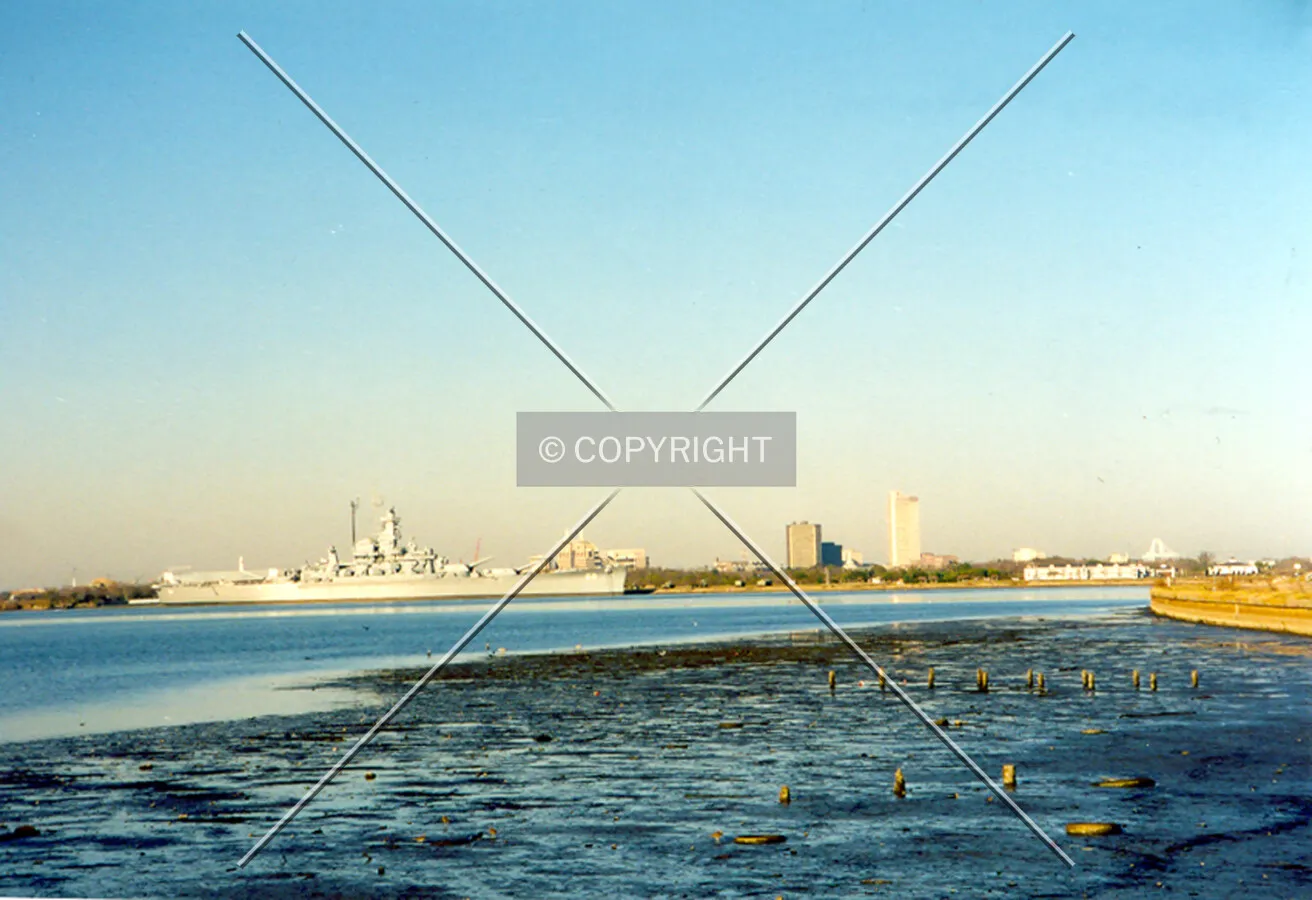Looking west towards the downtown skyline before the completion of the Battle House Tower with the U.S.S. Alabama resting in Mobile Bay off U.S. Highway 90