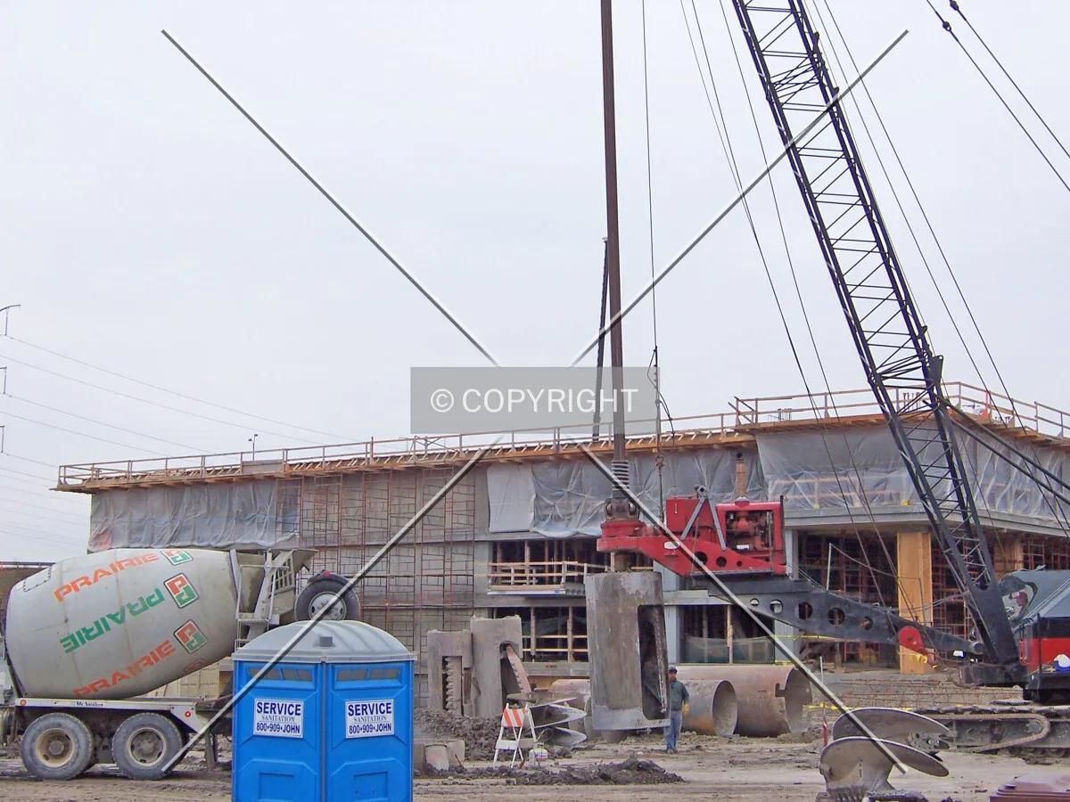 A bell bucket tool on a caisson drilling crane for widening the bottoms of the Maple Tower's caisson shafts before they are filled with rebar and concrete
