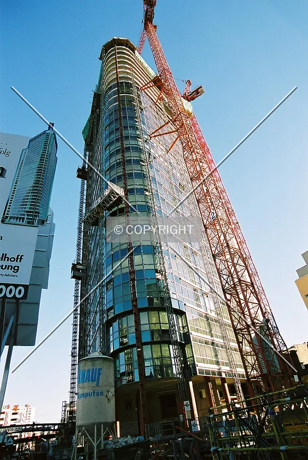 View to the top of the tower from nearby main entrance of the construction site