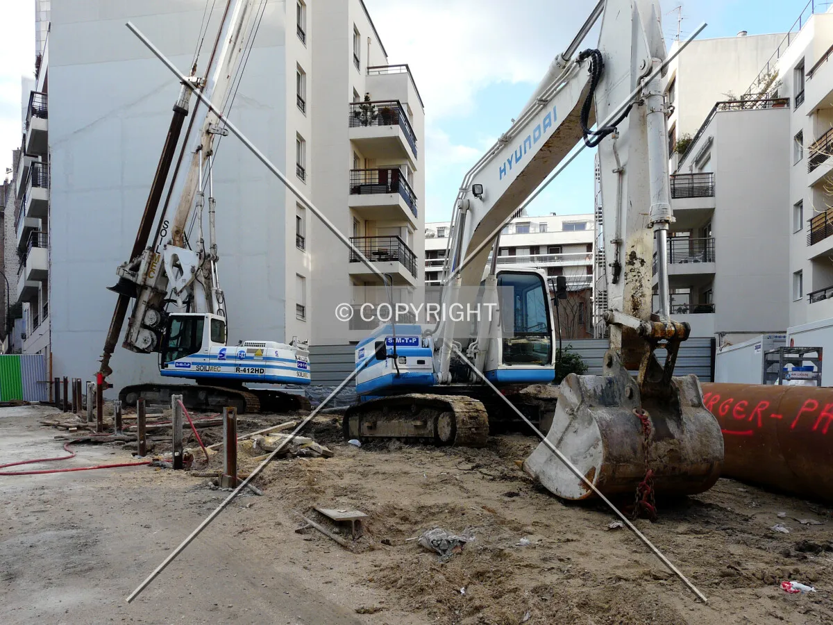 Drilling rig and digger on site