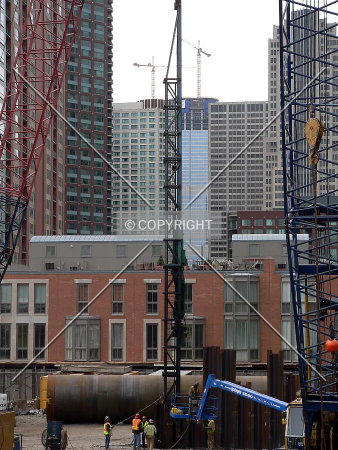 A pile driver used to pound steel sheeting for the core into the ground, with Trump Tower visible in the background