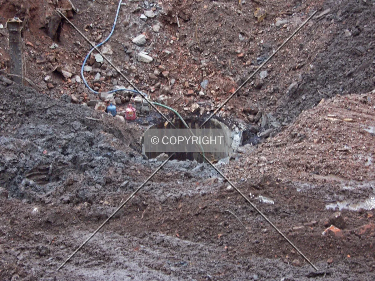 Excavated area and an uncovered shaft in the center of the site