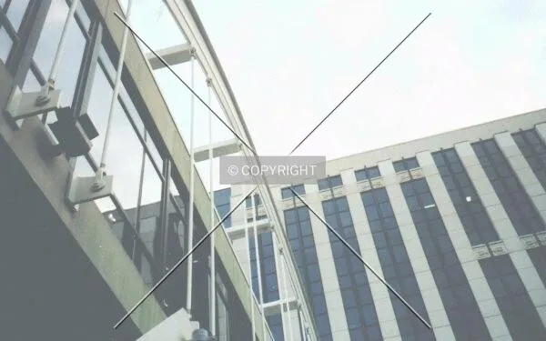 Pedestrian bridge over Beckham Avenue and building facade. View from south