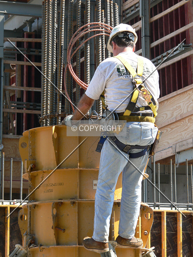 A worker checking the formwork around a soon-to-be column