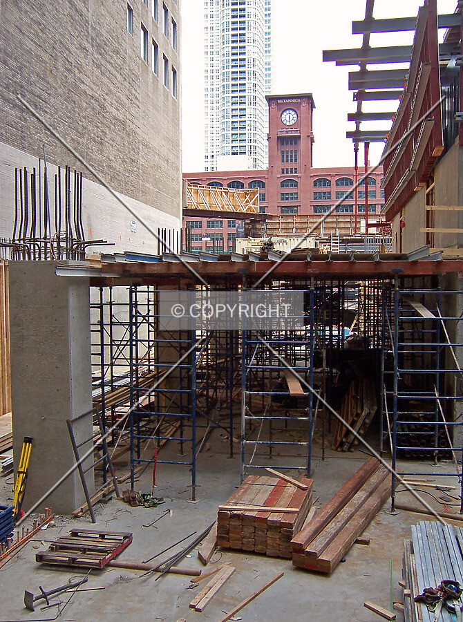 Looking north across the site from the alley. Scaffolding and temporary decking is in place for the pouring of the first floor concrete slab