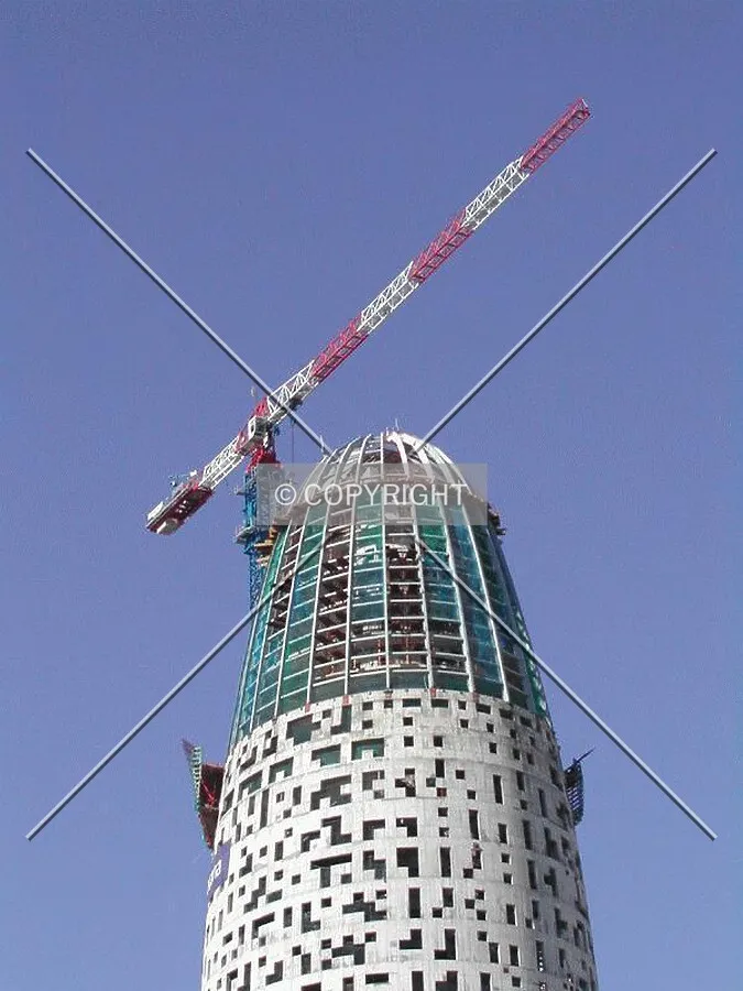 The crane overpassing the building top