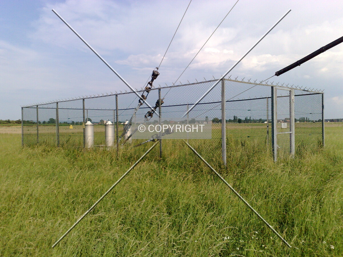 The steel ropes of the radio mast mounted to the ground