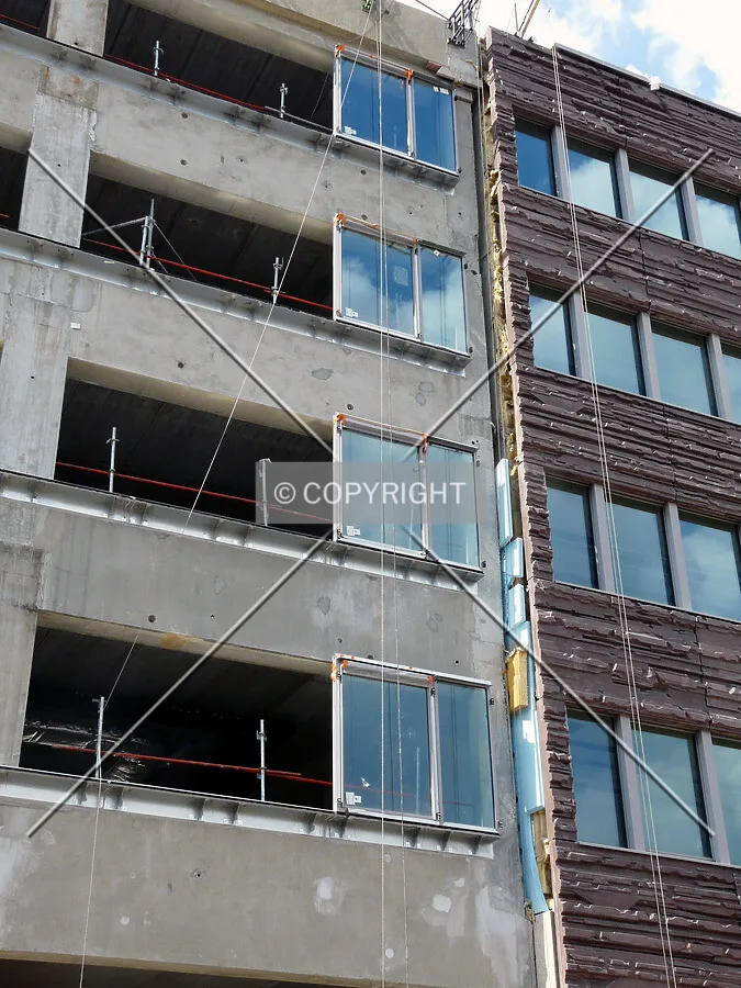 Facade and windows installation, with Dueo on the right (same facade completed)