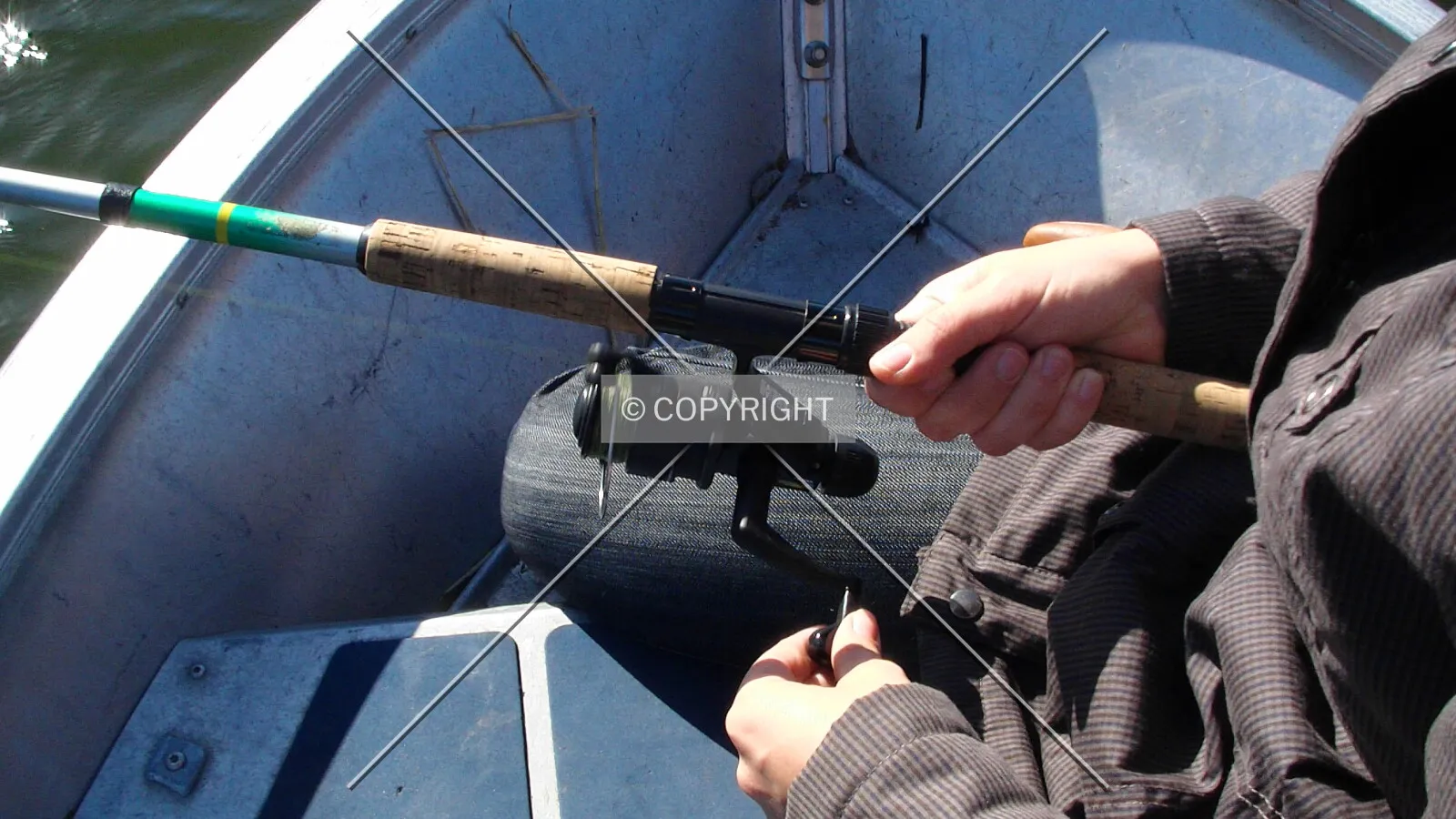 A man is holding an angling rod