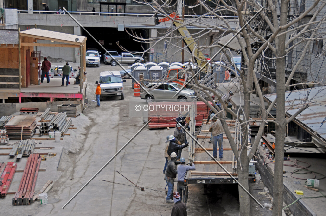 Workers unloading a flatbed truck on Carroll Avenue