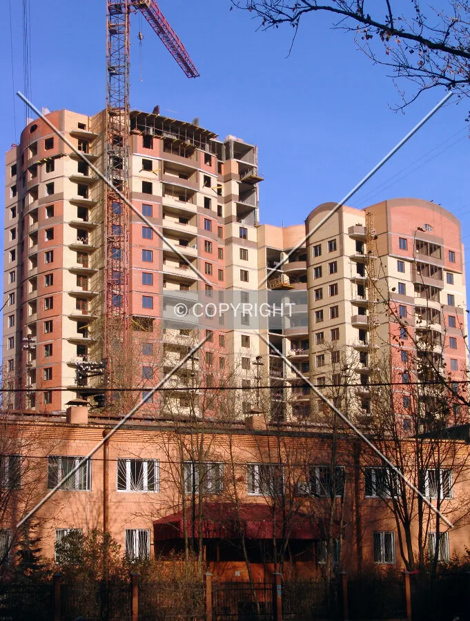 Towering over a low-rise neighboring building