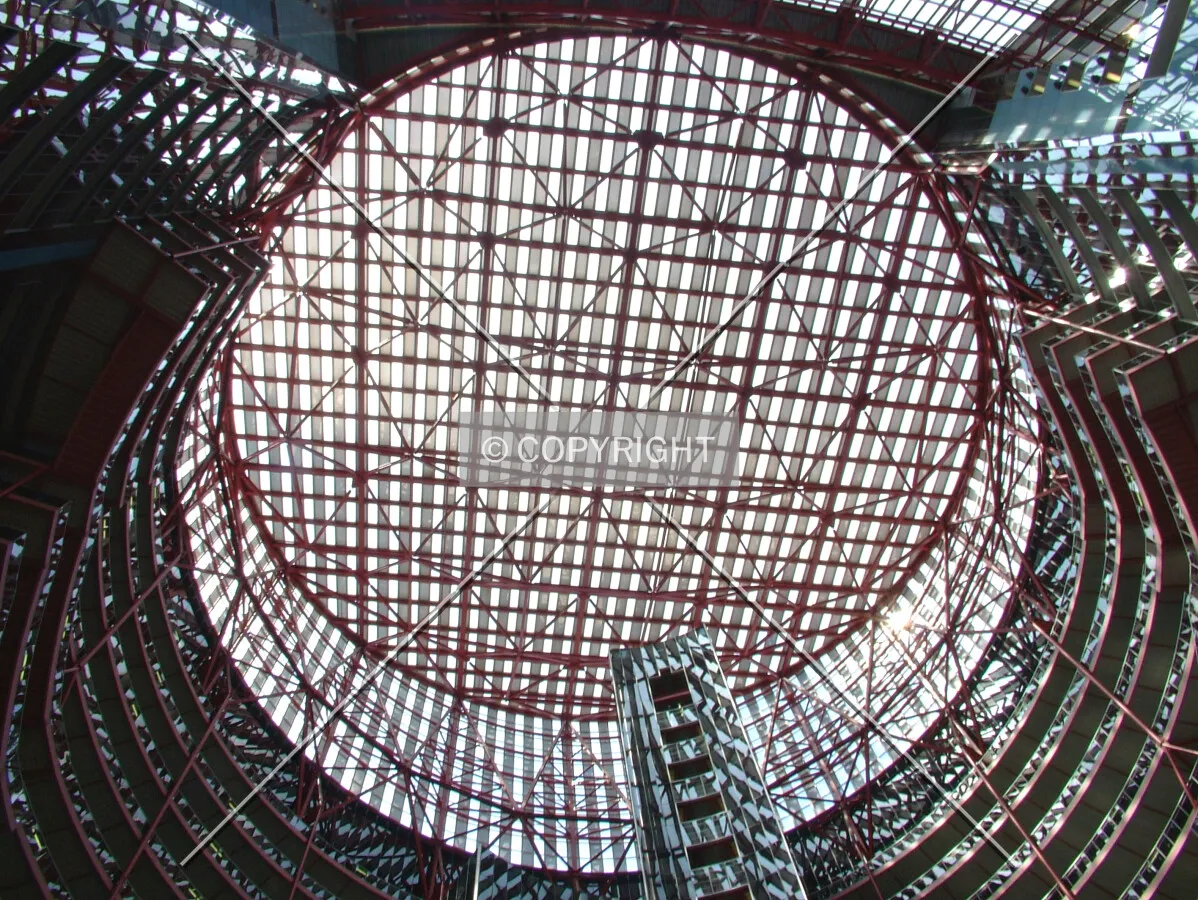 Glass and steel sloped roof as seen from the center of the lobby