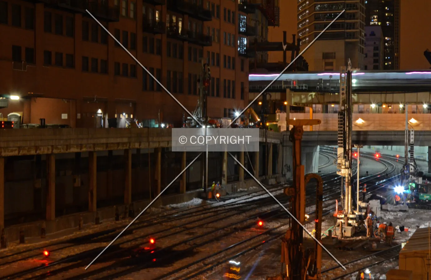 Drilling caissons between active railroad tracks, looking north from Randolph Street; February 13, 2015.