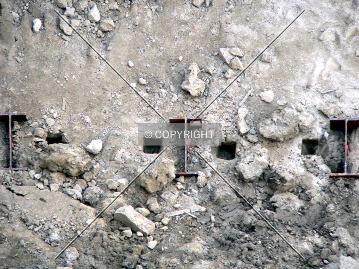 Recently driven steel piles visible