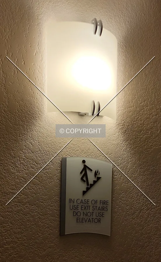 Light and sign between the elevator doors; March 19, 2021