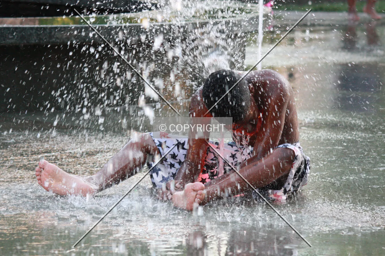 Boy getting splashed with water