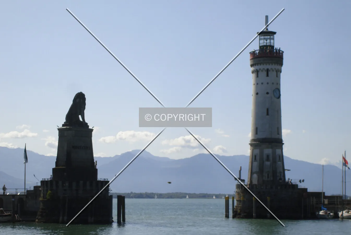 Lion sculpture and lighthouse at the gateway to Lindau Harbor