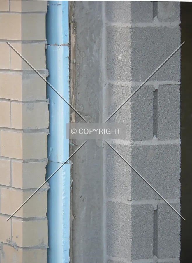 Layers of construction: Brick, foam-board insulation and concrete block