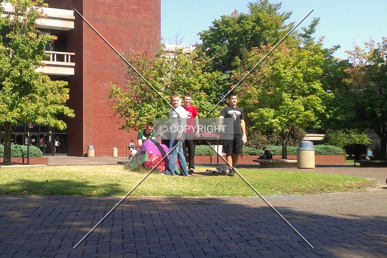 Students spray painting the rock in the Quad