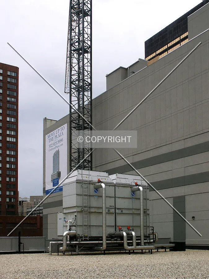 The new tower crane reaching up the side of the parking structure