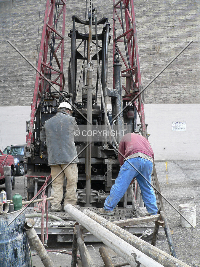 Workers running the soil testing drill
