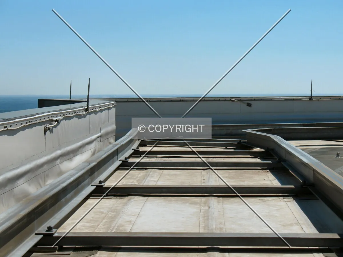 Tracks for the window-washing equipment and the low parapet