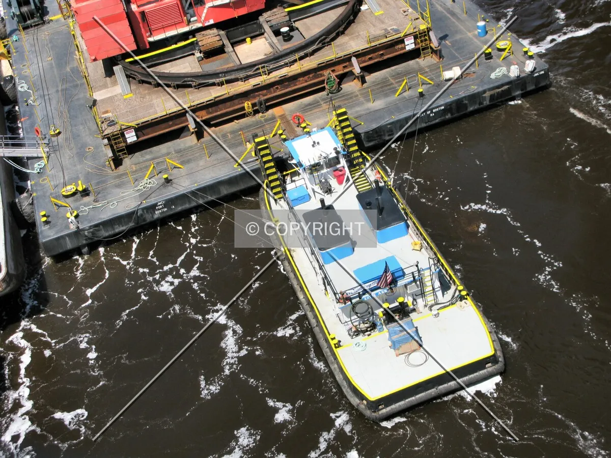 One of the tugboats keeping the barge and crane in place