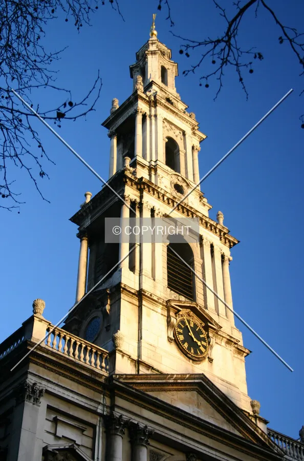 Looking up from the Strand at the tower lit gold by the evening winter sun