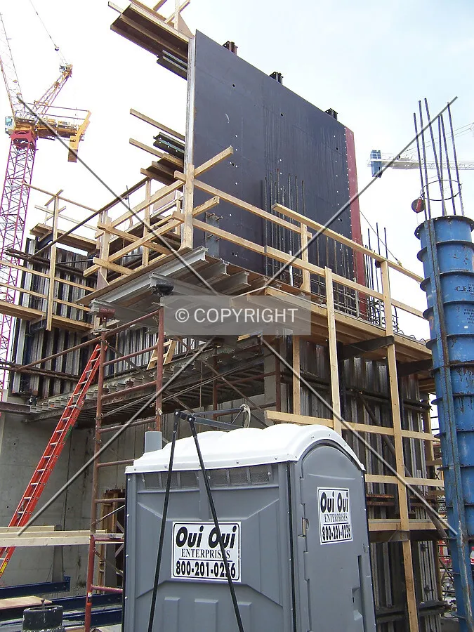 Concrete forms and scaffolding framing the elevator core in the southwest corner of the complex, located at the intersection of Davis Street and Benson Avenue