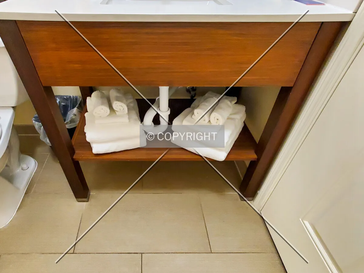 Towels folded under a guest bathroom sink; January 23, 2021